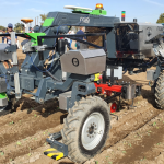 a picture of an autonomous farm tractor in a field