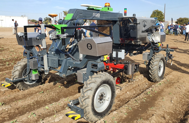 a picture of an autonomous farm tractor in a field